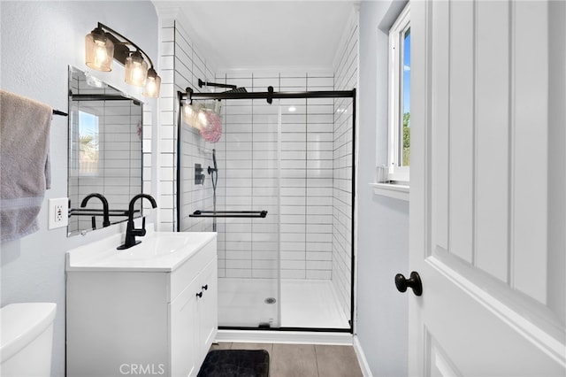 bathroom featuring vanity, toilet, ornamental molding, and walk in shower