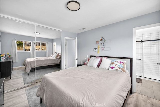 bedroom featuring light wood-type flooring and a closet