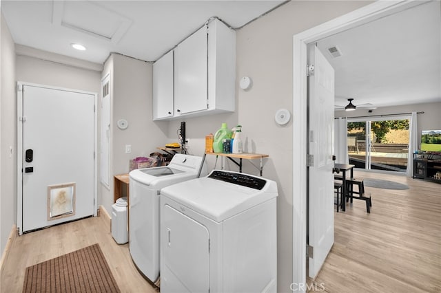 laundry area featuring cabinets, ceiling fan, light hardwood / wood-style flooring, and washing machine and clothes dryer