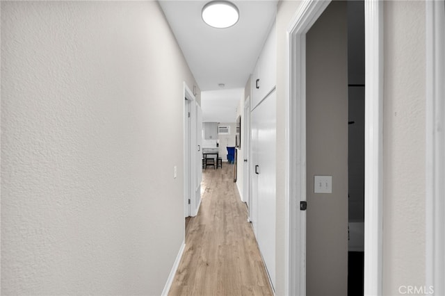 corridor featuring light hardwood / wood-style flooring