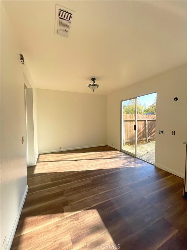 unfurnished room with dark hardwood / wood-style floors