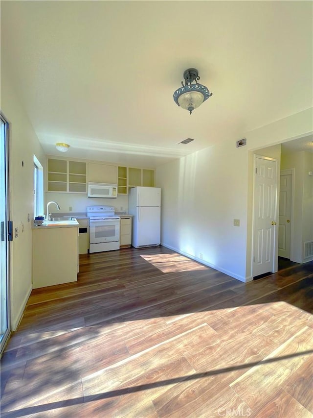 unfurnished living room featuring dark hardwood / wood-style flooring and sink