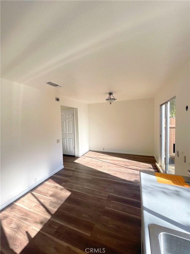 unfurnished living room featuring dark hardwood / wood-style flooring