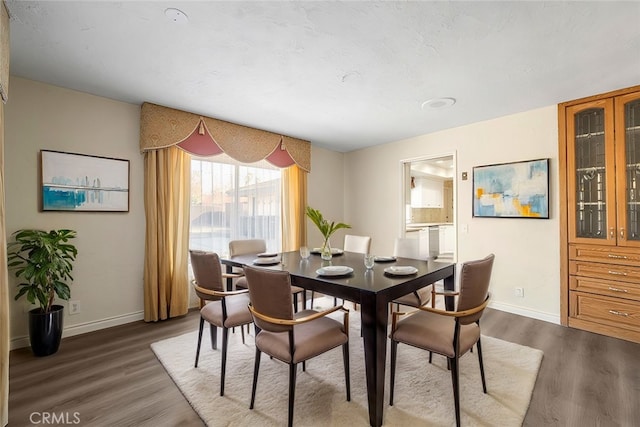 dining area with dark hardwood / wood-style flooring