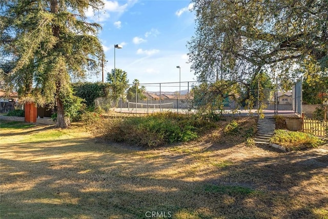 view of yard featuring tennis court