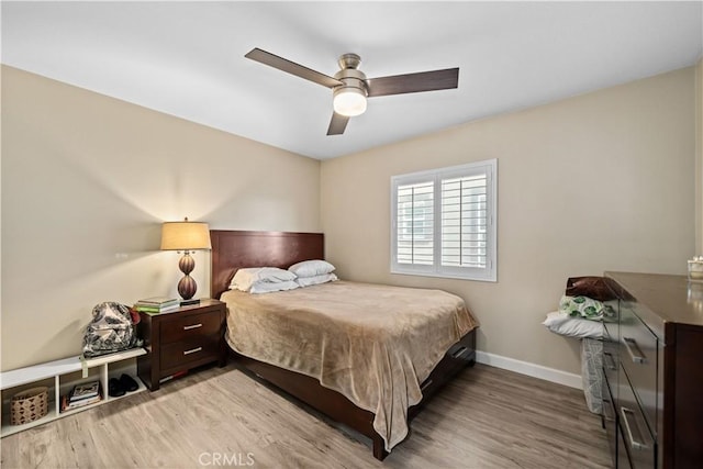 bedroom with ceiling fan and light hardwood / wood-style floors