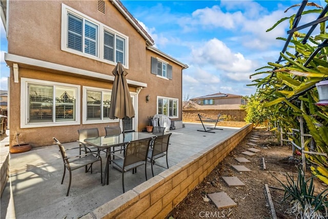 rear view of house featuring a patio