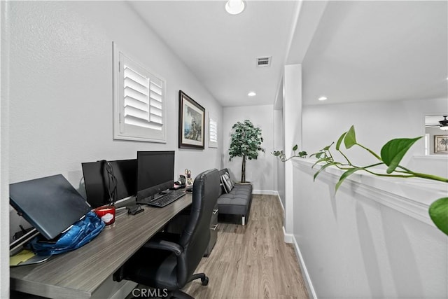 home office featuring plenty of natural light and light hardwood / wood-style floors