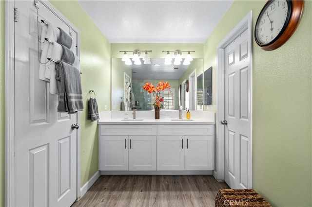 bathroom with hardwood / wood-style flooring and vanity