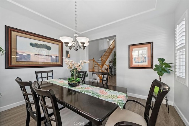 dining room with wood-type flooring and a chandelier