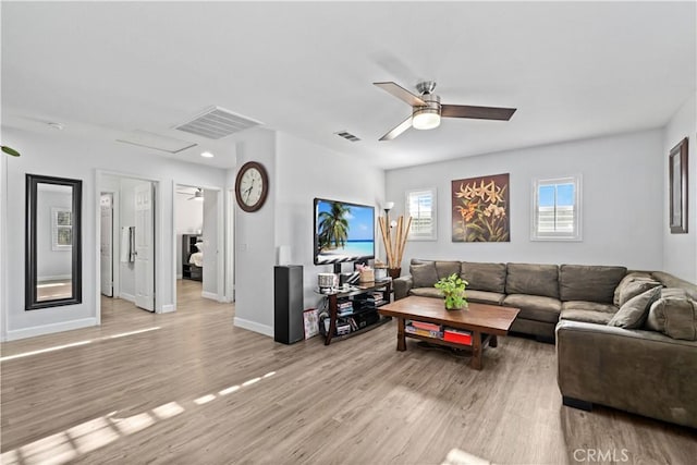 living room with light hardwood / wood-style floors and ceiling fan