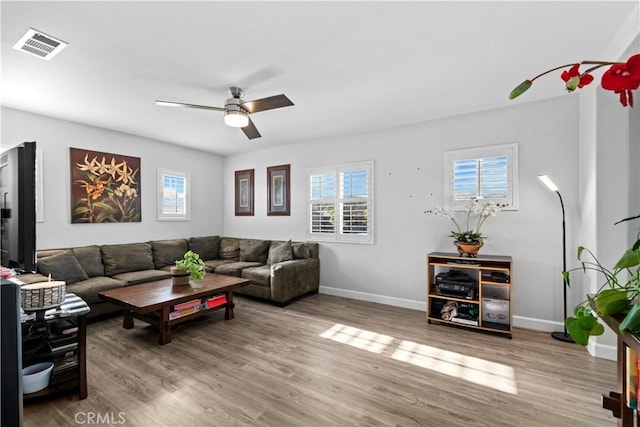 living room featuring light wood-type flooring and ceiling fan