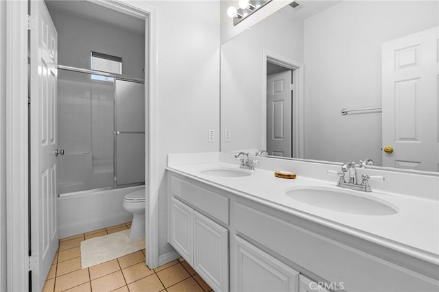 full bathroom featuring enclosed tub / shower combo, tile patterned floors, vanity, and toilet