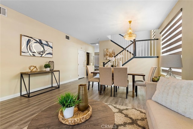 dining area featuring hardwood / wood-style floors and a notable chandelier