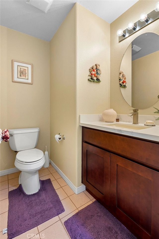 bathroom featuring toilet, vanity, and tile patterned floors