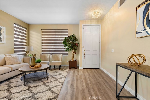 entryway with a notable chandelier and hardwood / wood-style floors