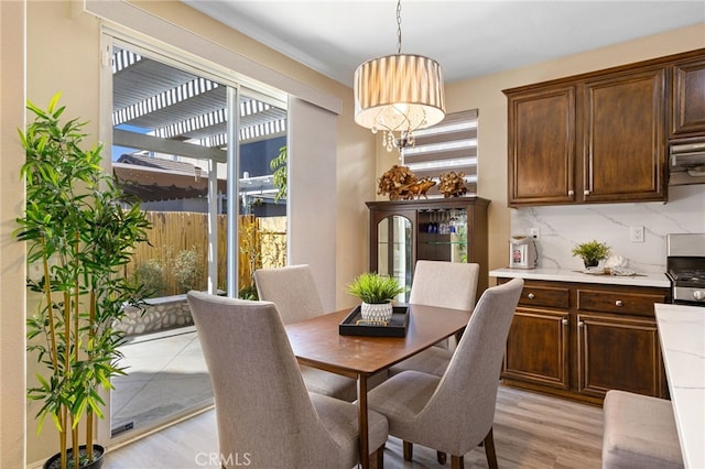 dining room with a notable chandelier and light hardwood / wood-style flooring