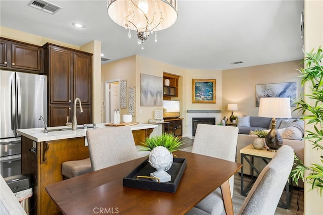 dining room with a chandelier and sink