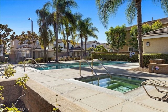 view of pool featuring a hot tub and a patio