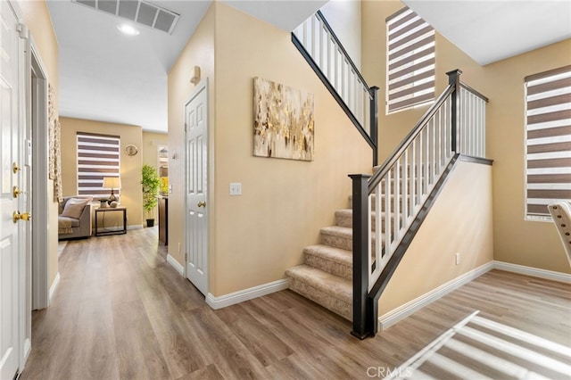 stairs with hardwood / wood-style flooring