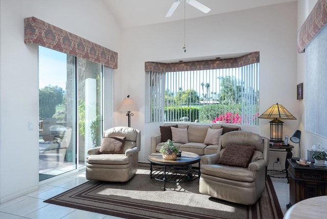 interior space with ceiling fan, tile patterned flooring, and lofted ceiling