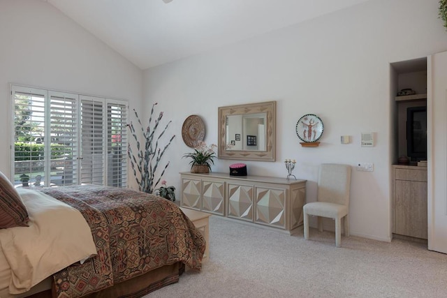 carpeted bedroom with high vaulted ceiling