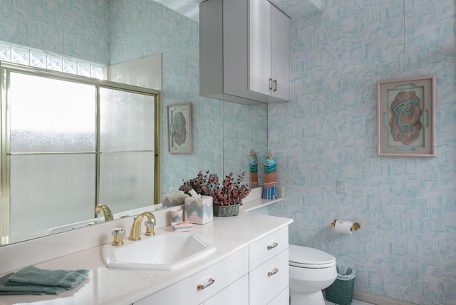 bathroom featuring toilet and vanity