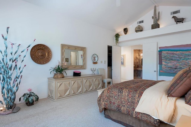 carpeted bedroom featuring ensuite bathroom and high vaulted ceiling