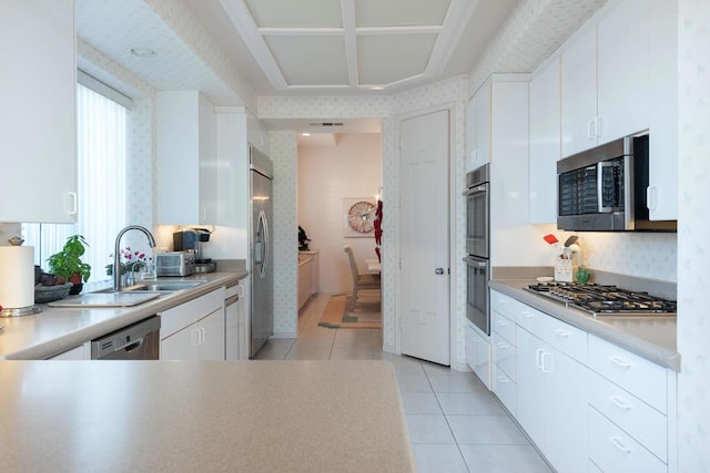 kitchen with light tile patterned floors, white cabinets, sink, and appliances with stainless steel finishes