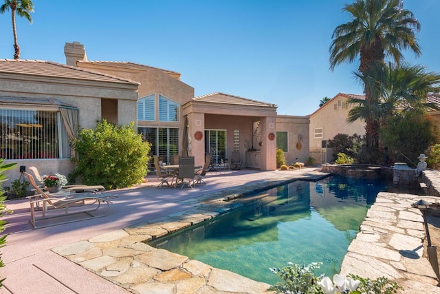 view of pool featuring an in ground hot tub and a patio