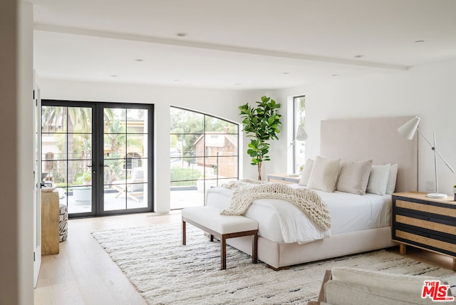 bedroom featuring light hardwood / wood-style flooring, access to outside, and french doors