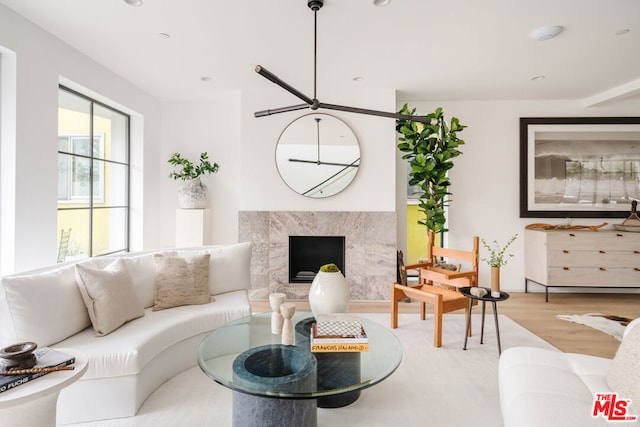 living room with an inviting chandelier and light wood-type flooring