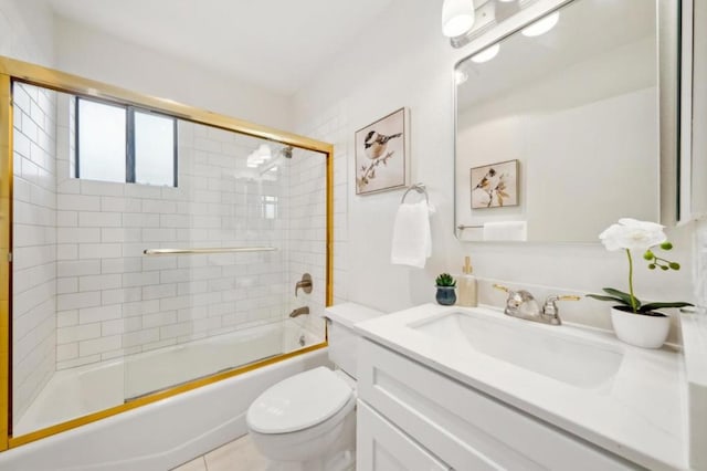 full bathroom featuring combined bath / shower with glass door, vanity, toilet, and tile patterned flooring