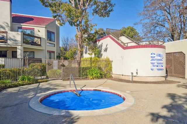 view of swimming pool featuring a community hot tub