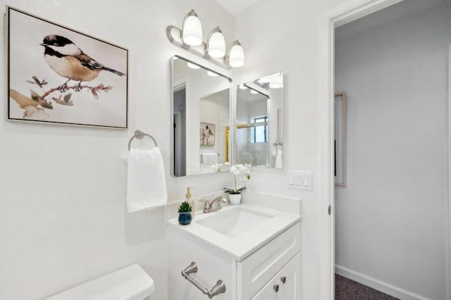 bathroom featuring toilet and vanity