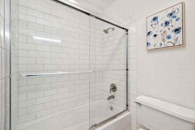 bathroom with toilet and enclosed tub / shower combo