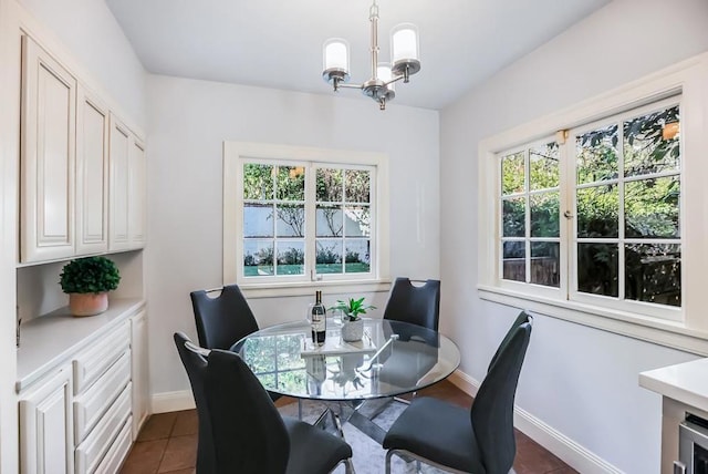 tiled dining room featuring a chandelier