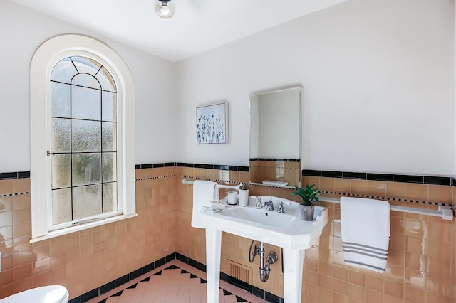 bathroom featuring tile walls and tile patterned flooring