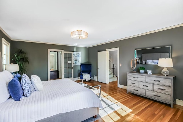 bedroom with crown molding and hardwood / wood-style flooring