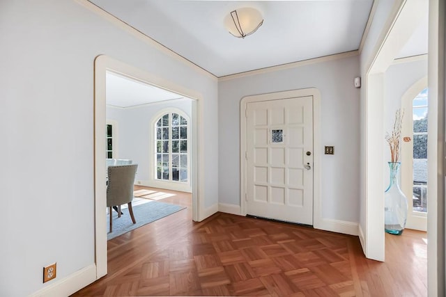 entrance foyer featuring ornamental molding and parquet floors