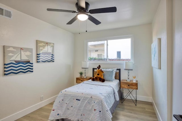 bedroom with ceiling fan and light hardwood / wood-style floors