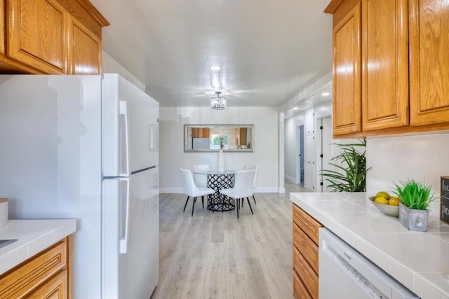 kitchen featuring light hardwood / wood-style floors and white appliances