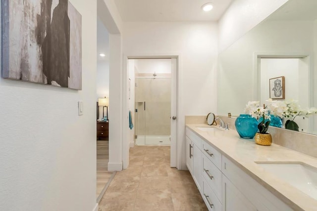 bathroom featuring vanity, tile patterned floors, and a shower