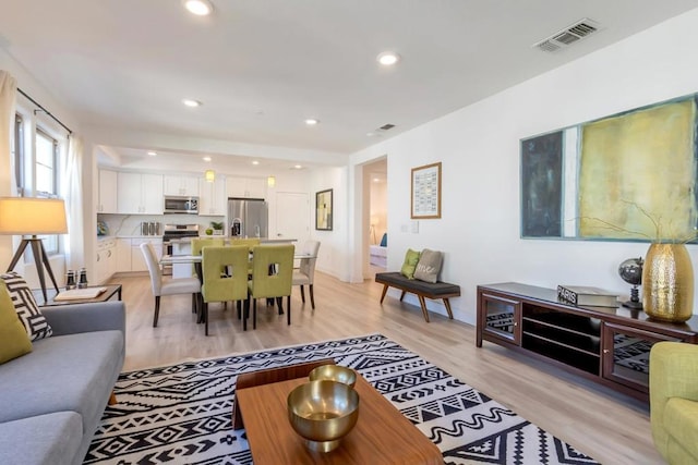 living room with light hardwood / wood-style flooring