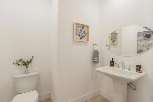 bathroom featuring toilet and hardwood / wood-style floors