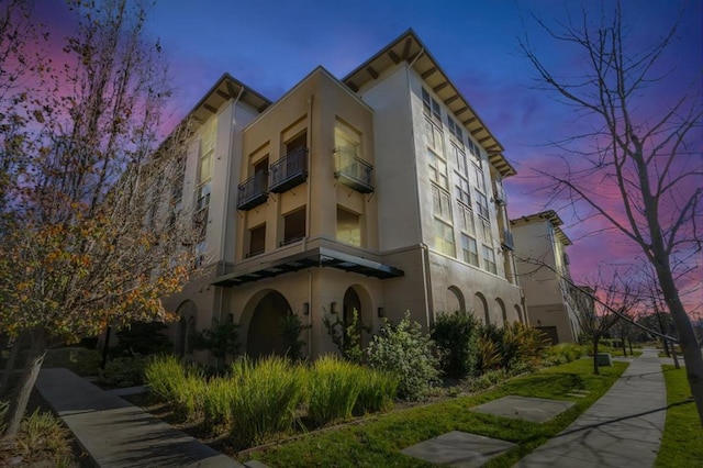 view of outdoor building at dusk