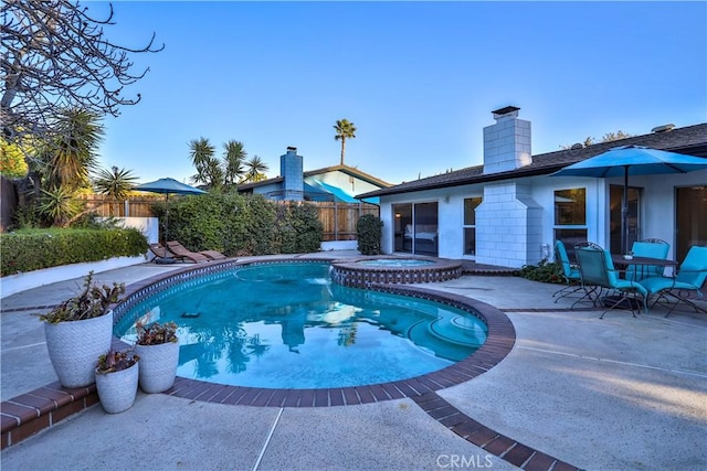 view of pool with an in ground hot tub and a patio