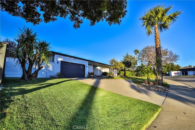 view of front facade with a front yard and a garage