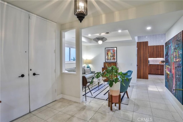 hallway featuring a tray ceiling