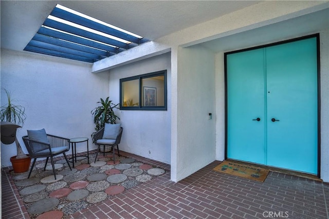 entrance to property with a pergola